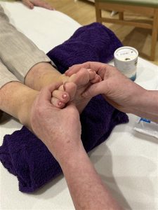 A person enjoying a relaxing foot massage from another person.