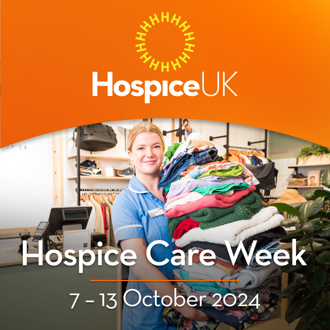 Hospice Care Week celebration in October 2024, highlighting compassion and support for patients and families in need. Image shows a nurse holding a pile of clothing in a charity shop. She is smiling.