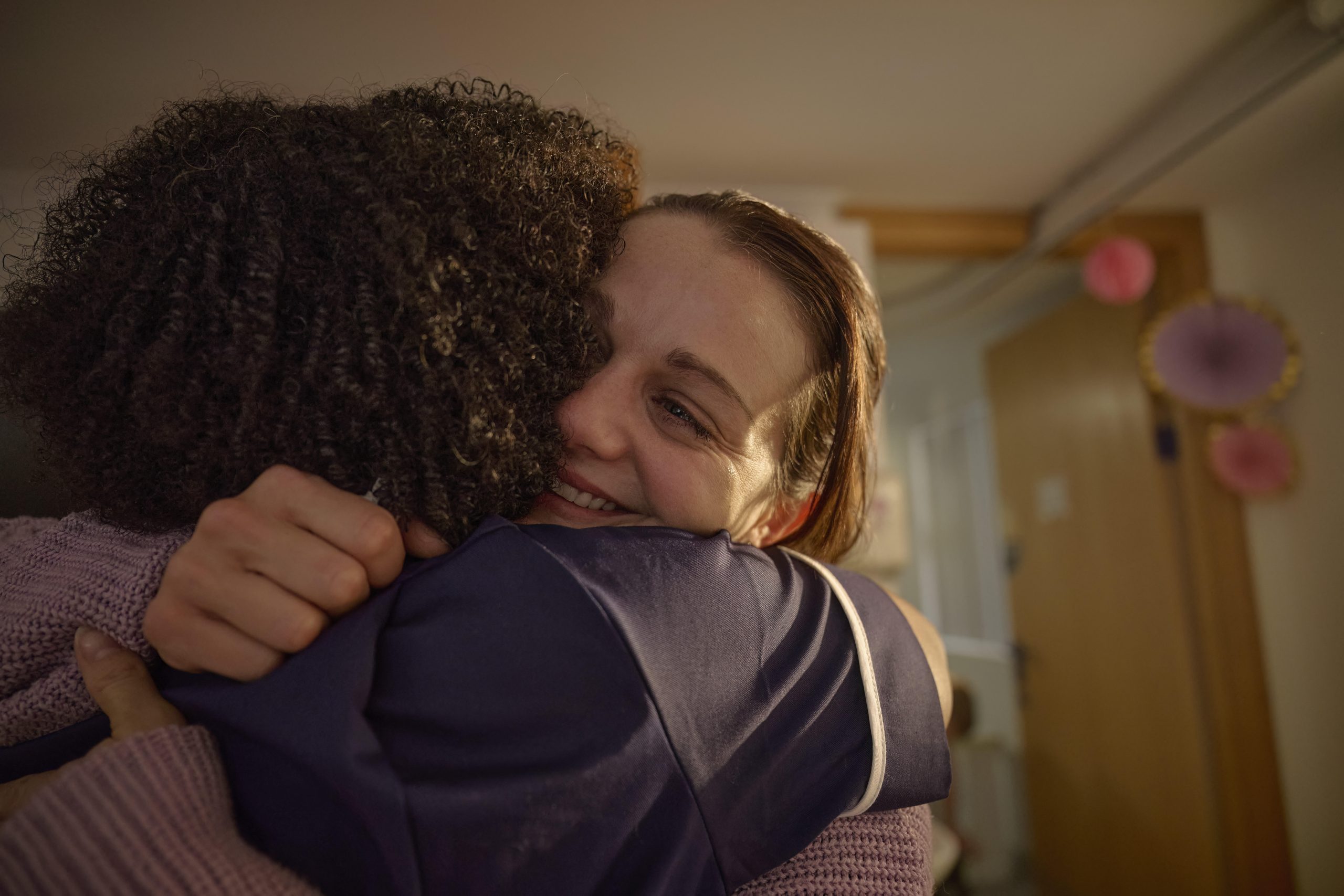 A nurse hugs a woman